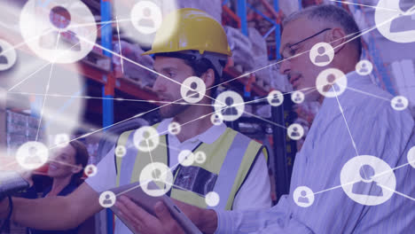 Animation-of-network-of-connections-with-icons-over-diverse-workers-in-warehouse-talking