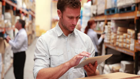 Warehouse-manager-using-his-tablet-pc