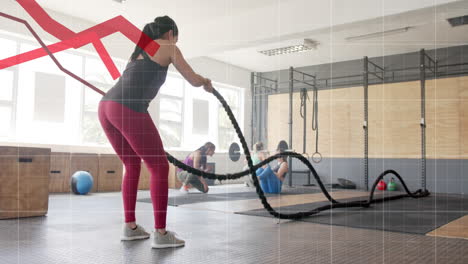 Animation-of-graph-processing-data-over-caucasian-woman-cross-training-with-battle-ropes-at-gym