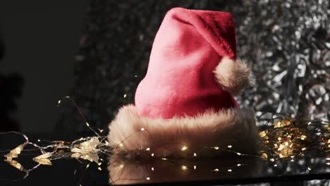 Video-of-christmas-santa-claus-hat-and-copy-space-on-black-background