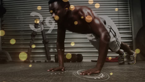 Animation-of-glowing-lens-flare-and-counter-over-african-american-man-doing-push-up-in-gym
