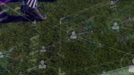 Animation-of-network-of-connections-with-icons-over-football-on-grass