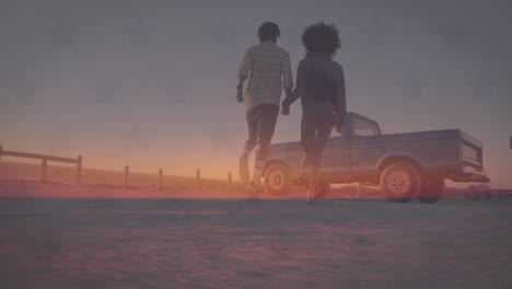 Animation-of-flag-of-america-over-happy-diverse-couple-running-to-truck-on-beach-at-sunset