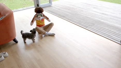 African-american-boy-using-vr-headset,-with-his-pet-dog,-copy-space,-slow-motion