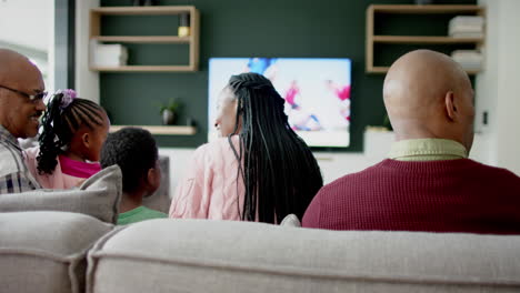 African-american-parents,-son,-daughter-and-grandparents-watching-rugby-with-copy-space,-slow-motion