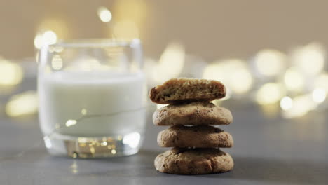 Video-of-christma-cookies,-glass-of-miljk-and-copy-space-on-grey-background
