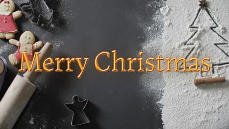 Merry-christmas-text-in-orange-over-tree-drawn-in-flour,-rolling-pin-and-cookies