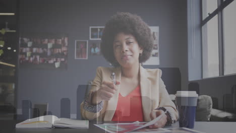 Animation-of-data-processing-against-african-american-businesswoman-having-video-call-at-office