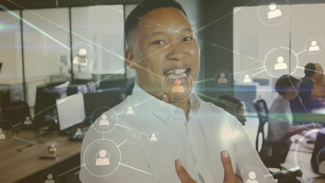 Animation-of-network-of-profile-icons-against-portrait-of-african-american-man-smiling-at-office