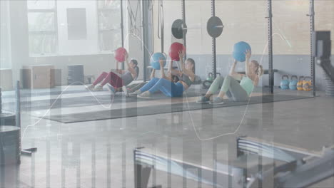 Animation-of-data-on-interface-over-diverse-women-holding-medicine-balls-cross-training-at-gym