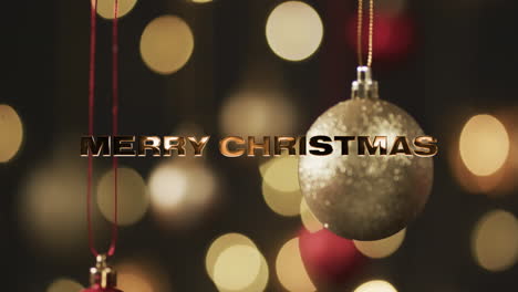 Merry-christmas-text-in-gold-over-baubles-and-bokeh-lights-on-dark-background