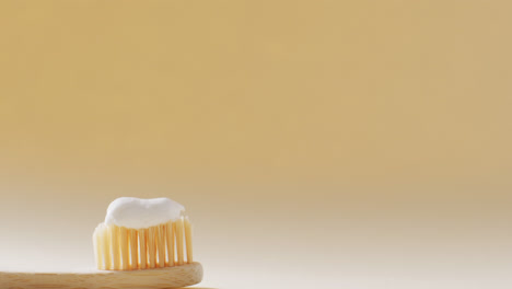 Close-up-of-toothbrush-with-paste-on-beige-background-with-copy-space