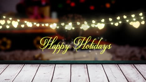 Animation-of-happy-holidays-text-and-hanging-fairy-lights-over-wooden-plank-against-decorated-house