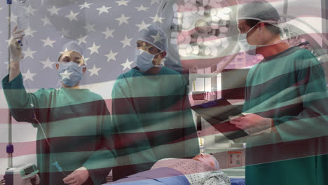 Animation-of-waving-usa-flag-over-team-of-diverse-surgeons-discussing-before-operation-at-hospital