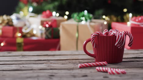 Video-of-red-mug-with-christmas-cnady-canes-and-christmas-presents-with-copy-space