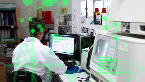 Animation-of-data-processing-against-rear-view-of-male-scientist-using-computer-at-laboratory