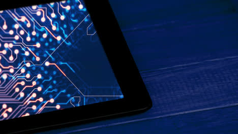 Animation-of-tablet-with-data-processing-on-blue-background