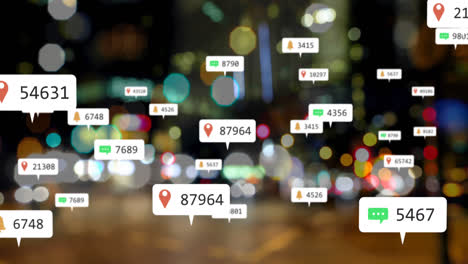 Animation-of-social-media-icons-floating-against-blurred-view-of-night-city-traffic