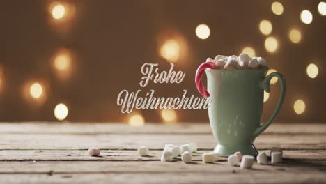 Animation-of-frohe-weihnachten-text-over-mug-of-chocolate-with-marshmallows-and-spots-of-light