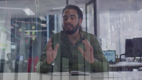 Animation-of-statistical-data-processing-on-portrait-of-biracial-man-talking-on-video-call-at-office