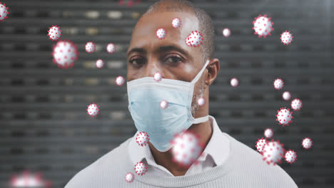 Animation-of-covid-19-cells-over-african-american-man-wearing-face-mask