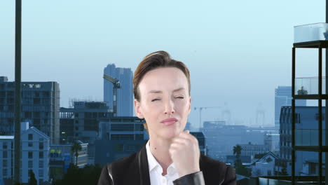 Composite-view-of-thoughtful-caucasian-businesswoman-against-aerial-view-of-tall-buildings