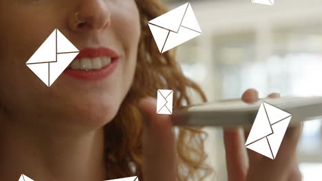 Animation-of-envelope-icons-falling-over-caucasian-woman-using-smartphone