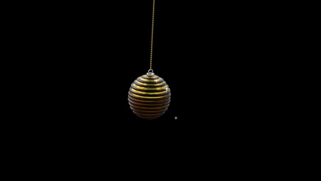 Black-and-gold-christmas-bauble-swinging-with-gold-sparkles-on-black-background