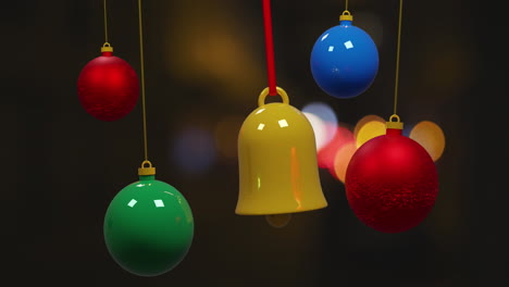 Colourful-christmas-buables-swinging-over-bokeh-lights-on-dark-background