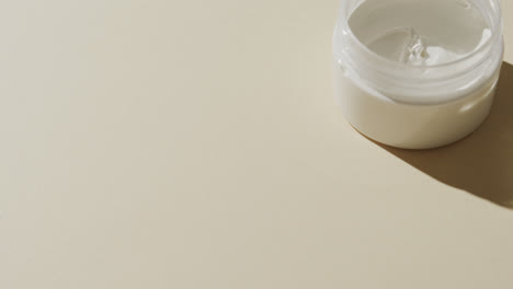 Close-up-of-cream-tub-with-copy-space-on-white-background
