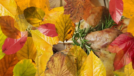 Animation-of-autumn-leaves-over-thanksgiving-dinner-background