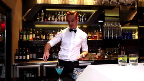 Attractive-bar-man-making-a-cocktail