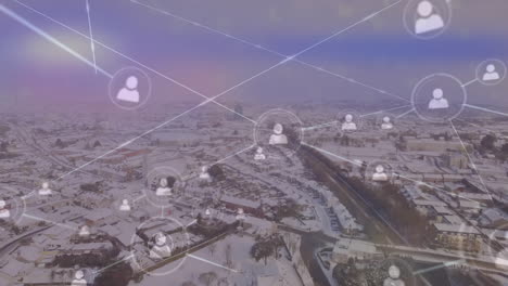Animation-of-network-of-profile-icons-and-light-spot-against-aerial-view-of-winter-landscape
