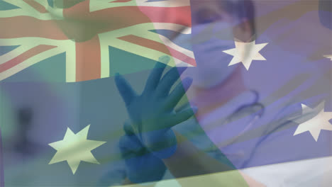 Animation-of-flag-of-australia-over-african-american-female-doctor-wearing-face-mask