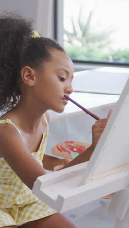 Video-of-focused-diverse-girls-painting-during-art-lessons-at-school
