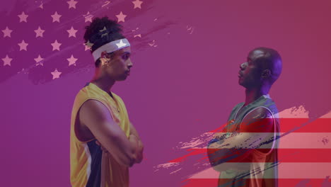 Animation-of-american-flag-over-african-american-male-basketball-opponent-players-facing-off