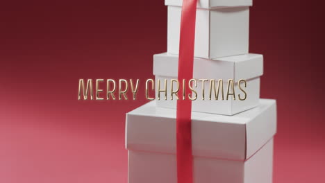 Merry-christmas-text-over-white-christmas-gifts-on-red-background