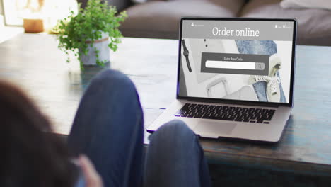 Knie-Einer-Frau-Am-Tisch-Mit-Laptop,-Online-Shopping-Für-Kleidung,-Zeitlupe