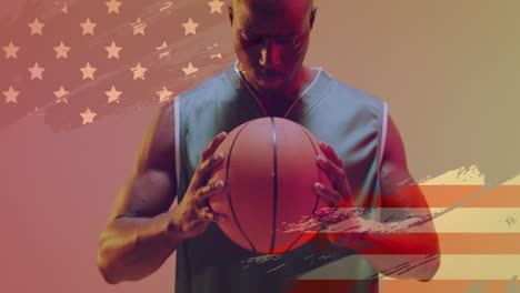 Animation-of-american-flag-over-focused-african-american-male-basketball-player-holding-ball