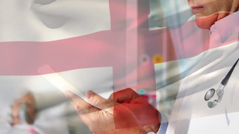 Animation-of-flag-of-england-over-caucasian-male-doctor-in-hospital
