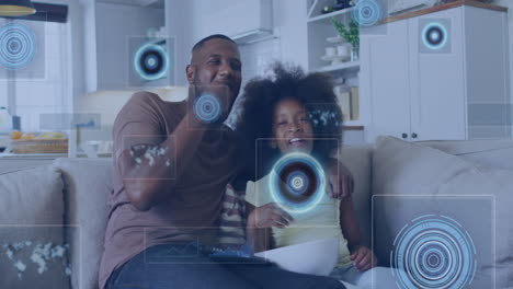 Animation-of-data-processing-against-african-american-father-and-son-watching-tv-at-home