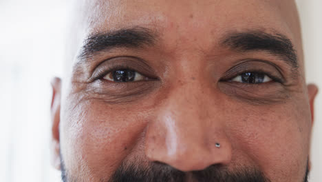 Close-up-portrait-of-happy-eyes-of-biracial-man-at-home,-slow-motion
