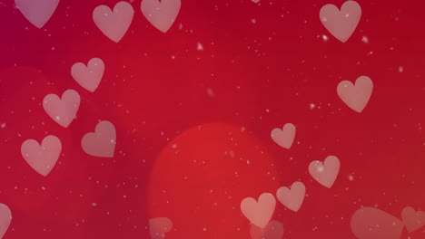Animation-of-white-particles-and-heart-icons-falling-against-spot-of-light-on-pink-background