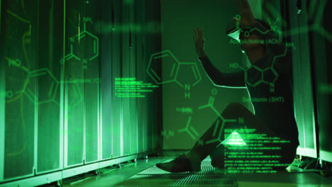 Animation-of-computer-language,-molecule-structures,-caucasian-man-using-vr-headset-in-server-room