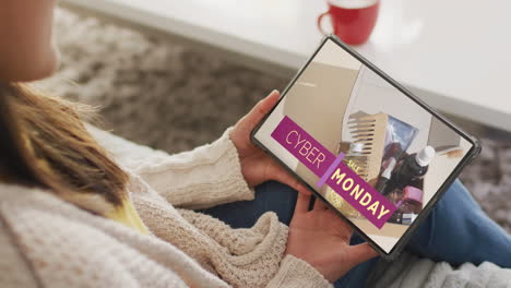 Caucasian-woman-using-tablet-at-home-online-shopping-on-cyber-monday-sale-day,-slow-motion
