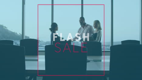 Animation-of-flash-sale-text-banner-over-diverse-businesspeople-discussing-shaking-hands-at-office