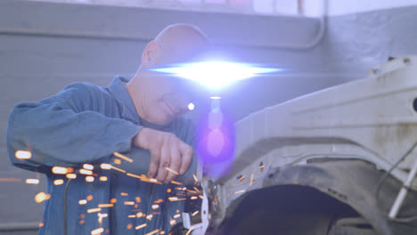 Animation-of-blue-light-moving-over-male-caucasian-mechanic-using-grinding-tool-on-car-in-garage