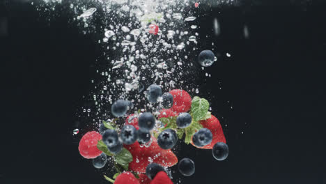 Video-of-berries-falling-underwater-with-copy-space-on-black-background