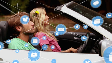 Animation-of-network-of-connections-with-icons-over-caucasian-couple-sitting-in-car