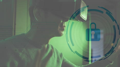 Animation-of-security-padlock-icon-against-asian-male-engineer-wearing-vr-headset-at-server-room